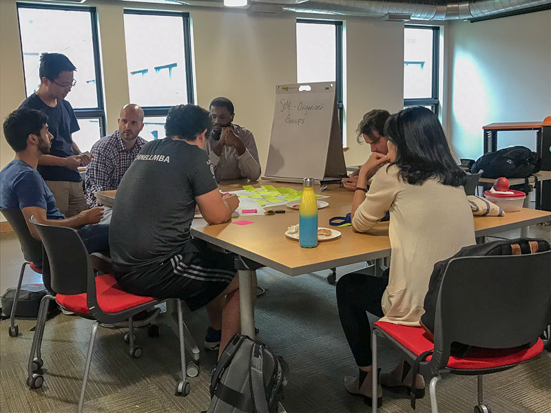 Photo of students working around a table