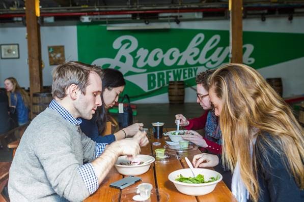 Photo of students sitting at a table at Brooklyn Brewery
