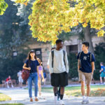 Photo of students walking and talking on the quad