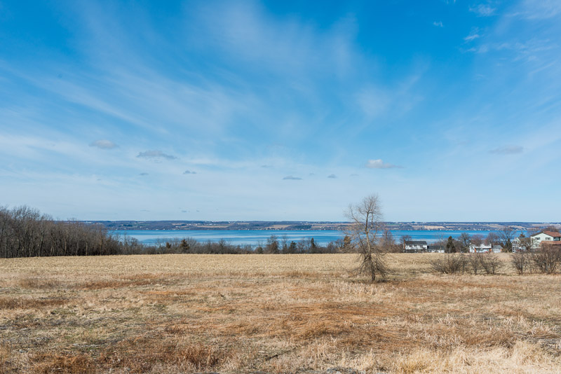 Photo of an empty field overlooking the lake