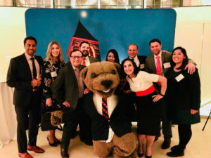 Photo of a group of people with Touchdown the bear at a reception