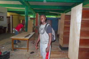 Photo of Nana among library bookshelves in the process of construction