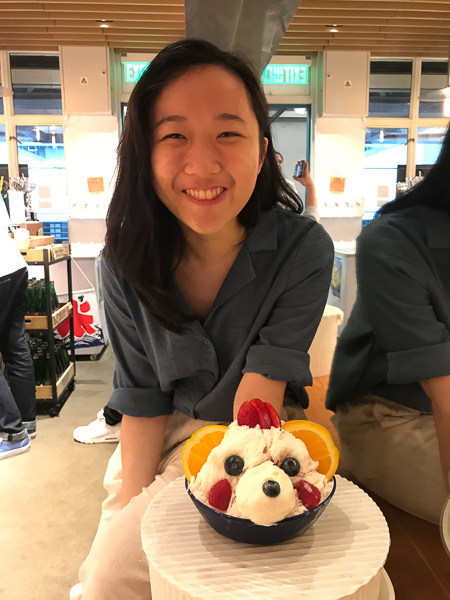 Photo of Nicole smiling with an ice cream sundae