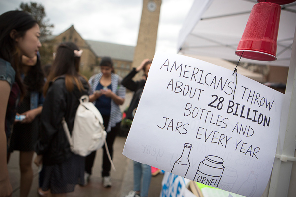 Photo of a sign that reads "Americans throw about 28 billion bottles and jars every year"