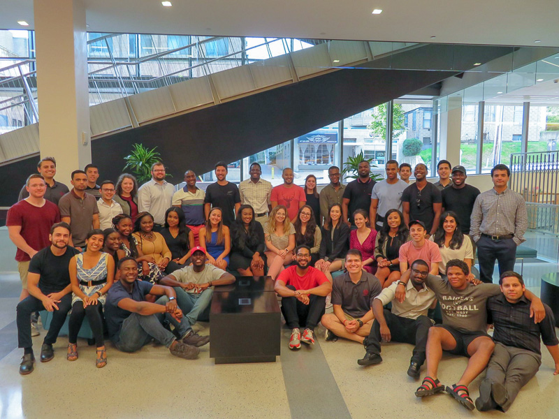 Photo of a large group of students standing in front of the Breazzano staircase