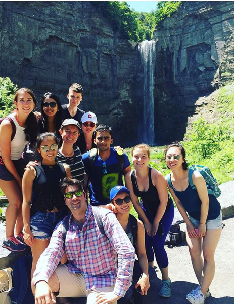 A group of MMH students pose for a photo in front of the falls.
