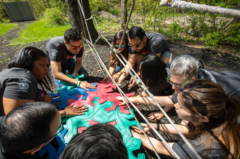 Photo of students working on an activity outdoors with puzzle pieces