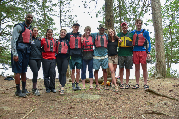 Students wearing life jackets in the woods