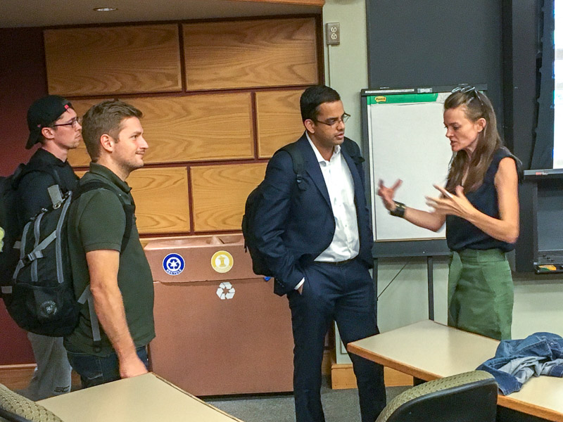 Carrie talks with students in the classroom