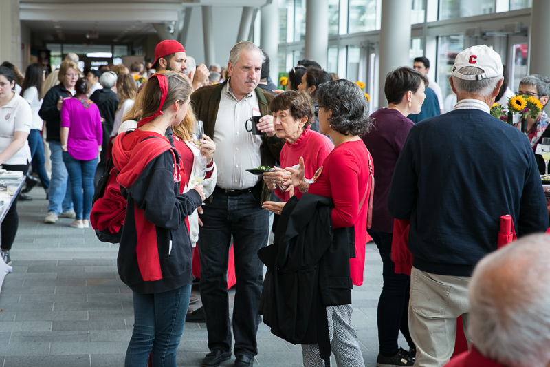 Photo of a crowd of alumni mingling at brunch