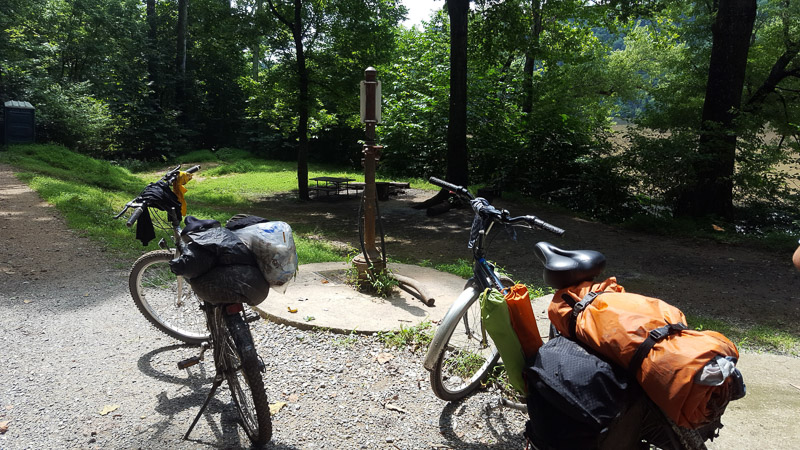 Two bikes standing on a path