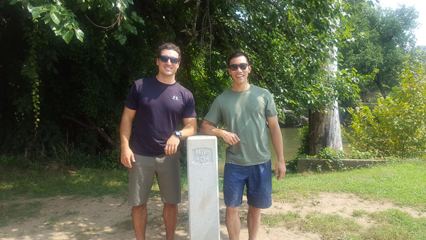 Keith and a friend standing at the mile marker 