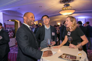 Guests talking and laughing around a high-top table