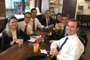 A group of students seated around a restaurant table