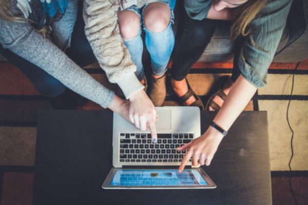 Group of people working together at a computer
