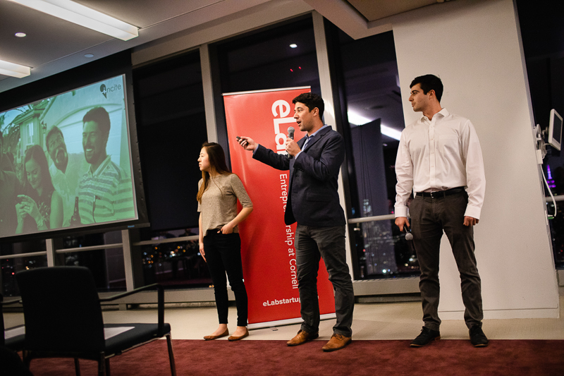 Three students present on stage