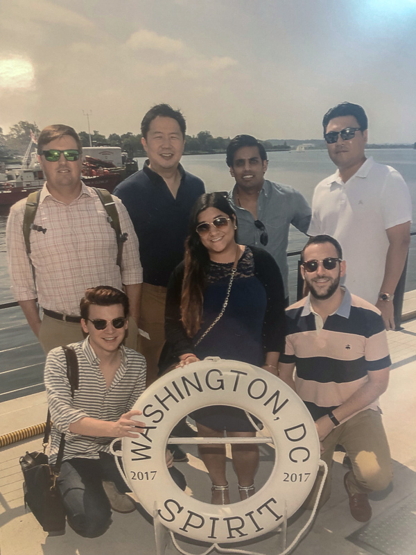 A group poses with a life saver that says Washington, DC Spirit