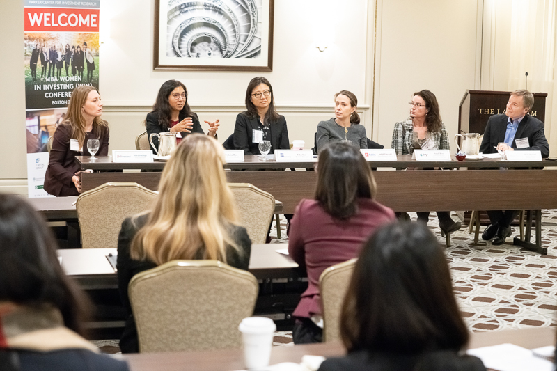 Five women speak on a panel with the moderator