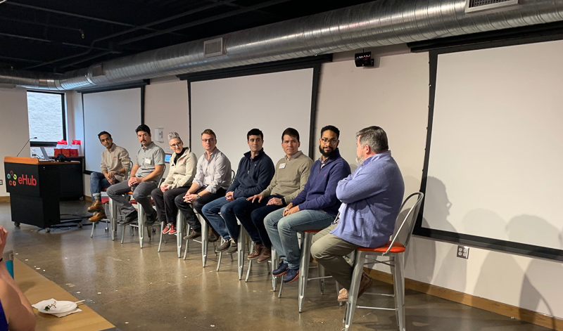 A panel discussion in the front of a room