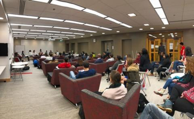 An audience listens to the panel