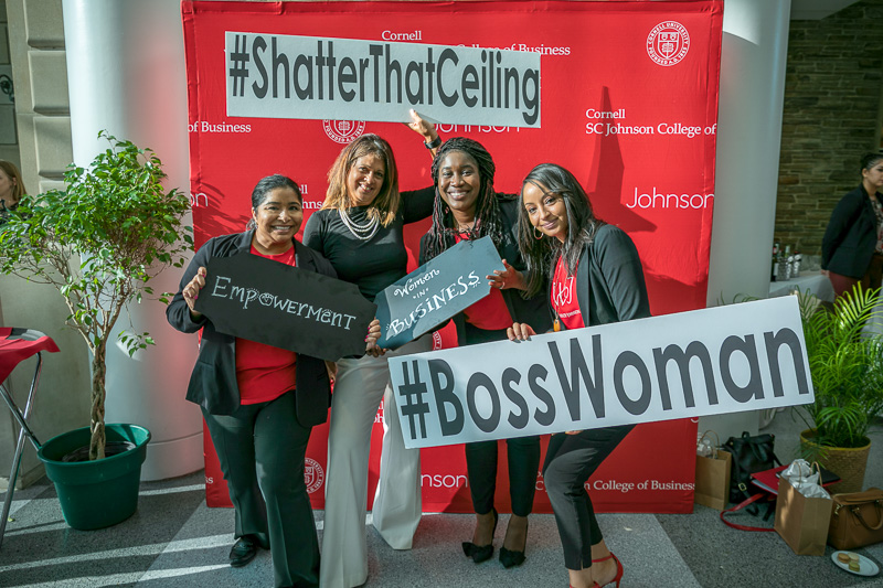 Four women pose with #bosswoman signs