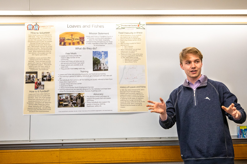 Student pointing to a poster project