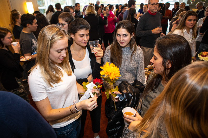 A group of students talking in a crowded room