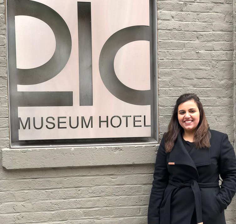 Anushae standing next to the Museum Hotel sign