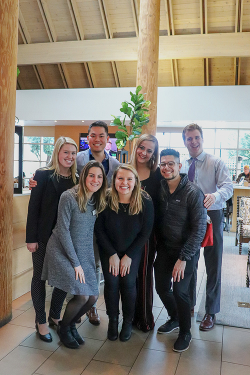 A group stands together inside the lobby