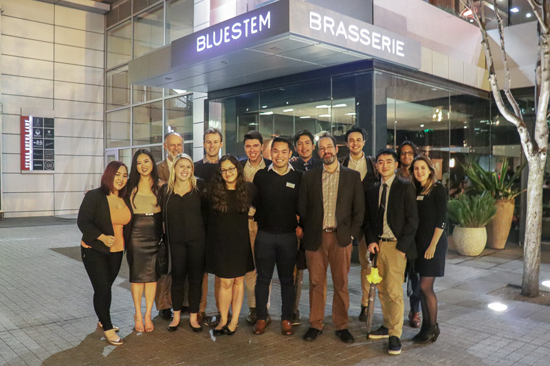 The group stands outside of the Bluestem building