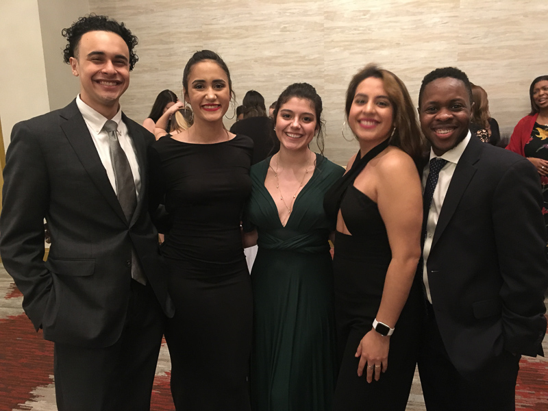 Students wearing formal attire and smiling