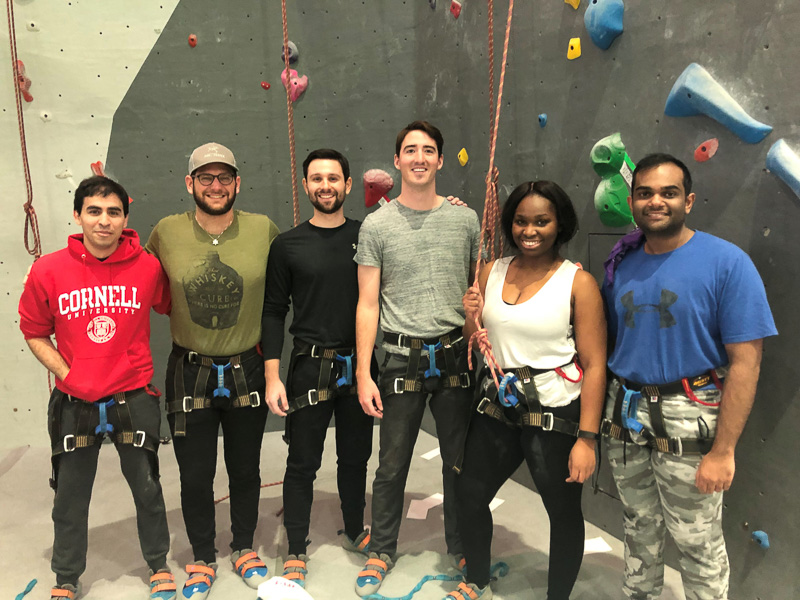 Students standing in front of the climbing wall