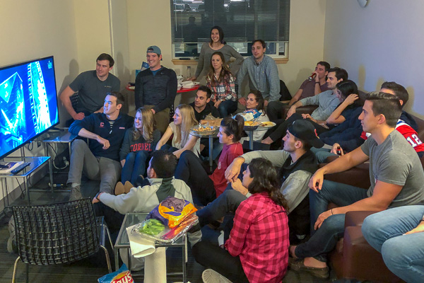 A large group of students watching TV