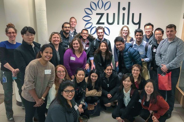 Students and visitors in front of a Zulily sign