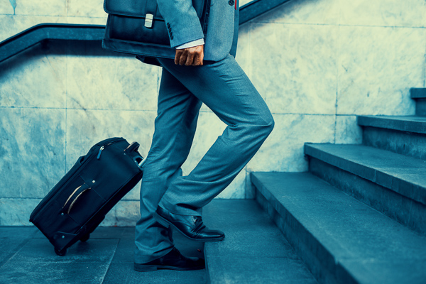 Walking up stairs with a suitcase