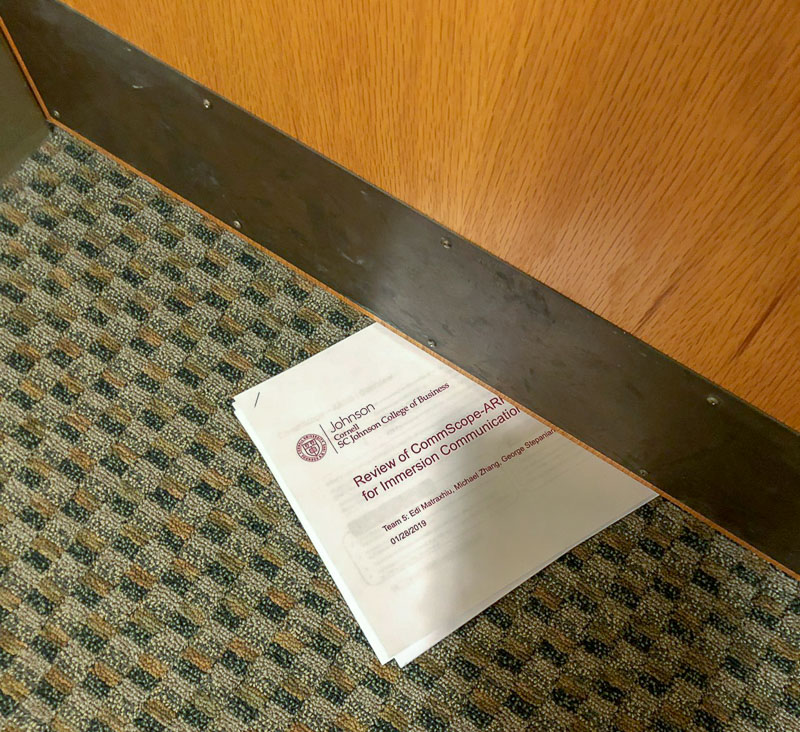 A print-out sticking out from under a door