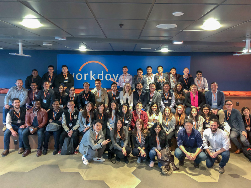 A large group of students in front of the Workday sign