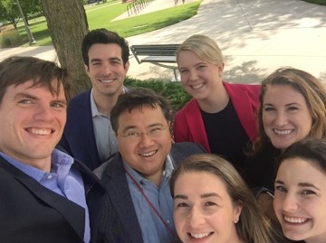 Group of seven people take a selfie