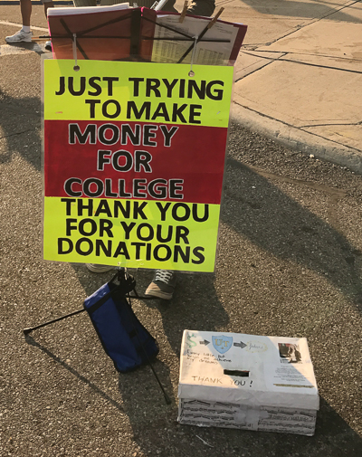 Andrea's sign during performances - "Money for college"