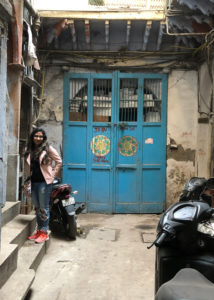 A student standing in front of a colorful door