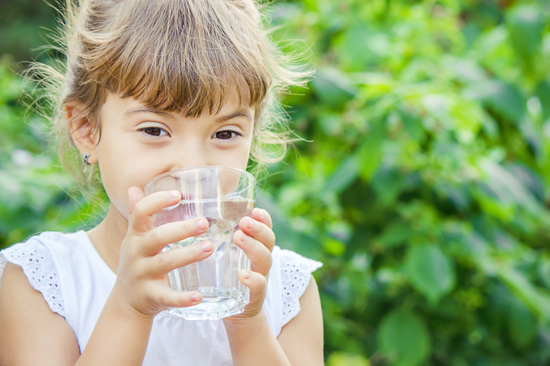 Child drinking a glass of water