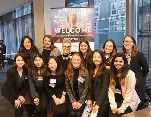 The JWiT group stands in front of the welcome sign