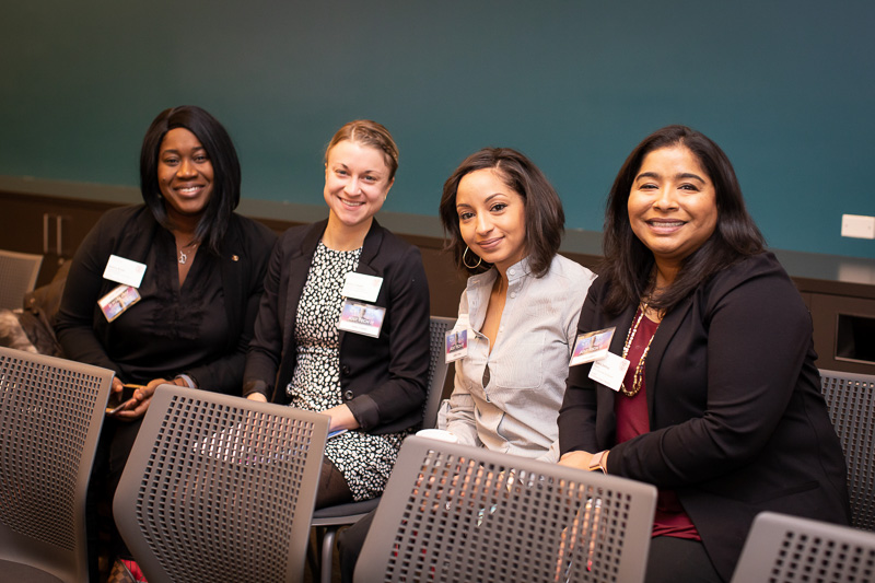 Four women sitting in the audience