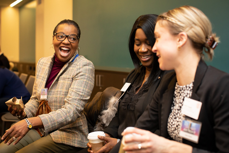 Three women laughing and smiling