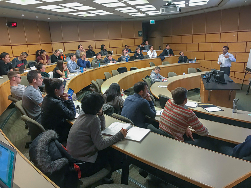 Guest speaker D.J. Rama addressing a classroom of students 