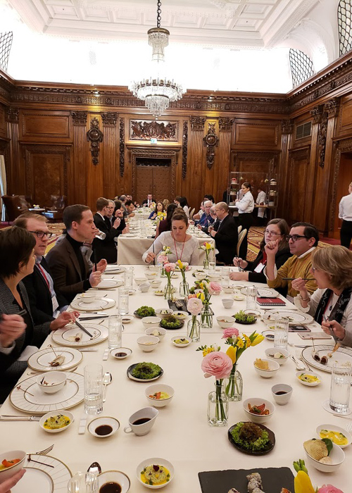 Faculty eataing a meal around a large table