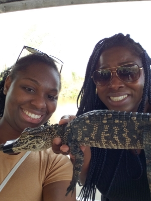 Classmates holding baby gator