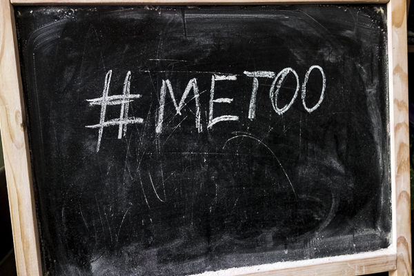 Chalk inscription on black chalkboard with hashtag Me Too