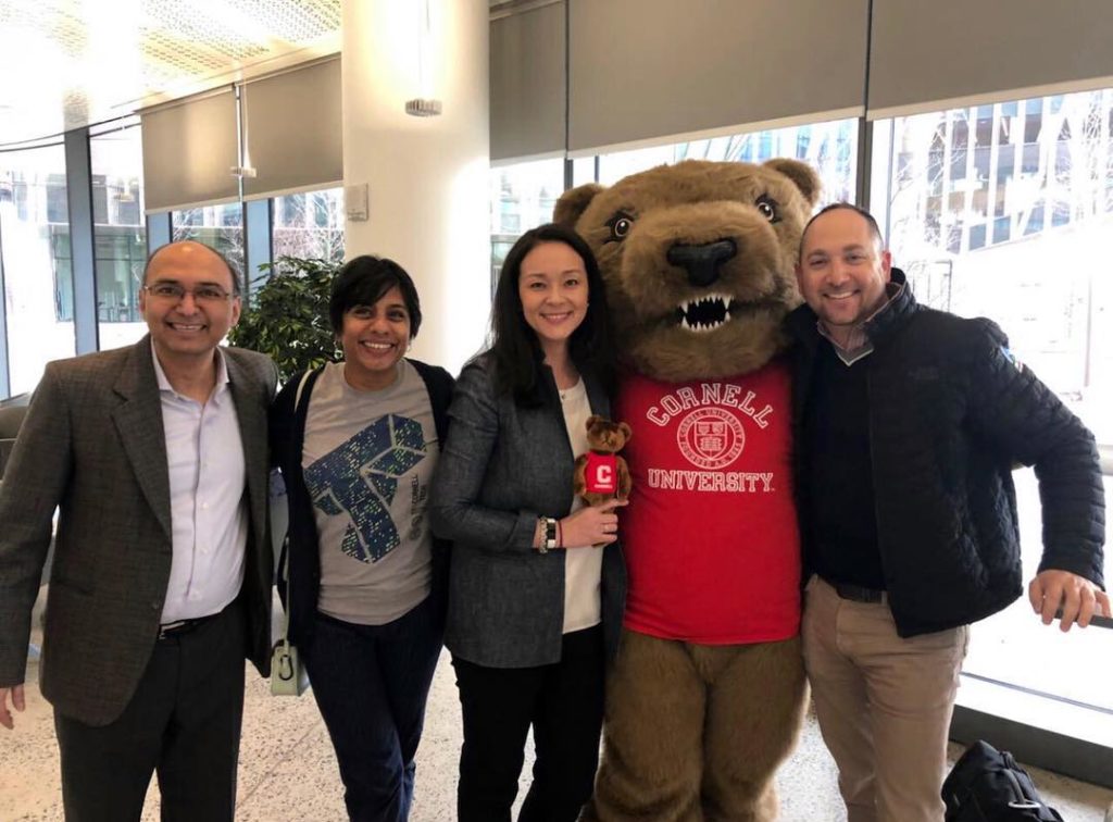 Admissions team and faculty poses with Touchdown the bear