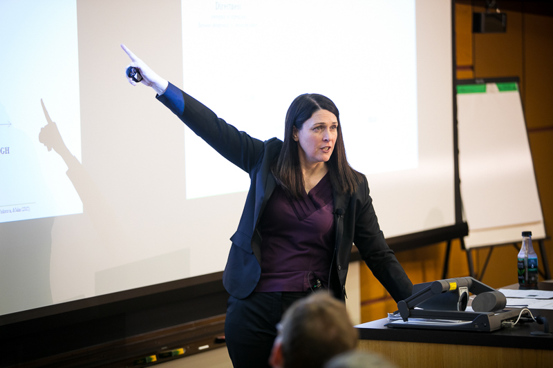 Kristin Behfar pointing to her Powerpoint presentation 